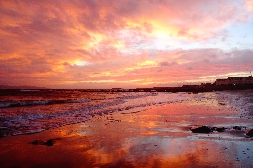 Nature created a wonderful colourful & expresive scene using the beach, water, sky & clouds