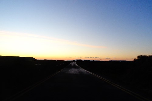 Early morning capture of a road leading to the ocean just before the sun rises