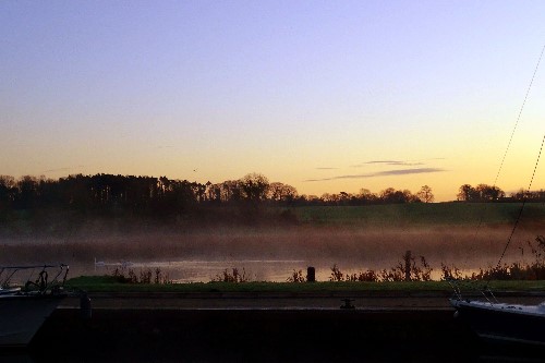 A misty morning in Terryglass Harbour looking out at swans & boats over lough Derg