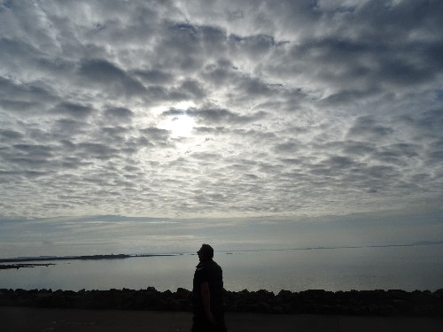 A man walking with a calm subtle enjoyment in the moment
