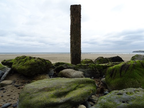 A pillar in the center of the image splits the Tramore beach in two in Waterford