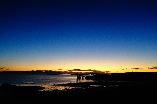 Salthill Galway looking like it has been painted in beautiful yellow & blue complimenting eachother