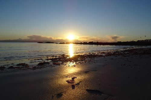 A calm sunset kissing the sand